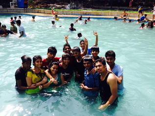 Elite Classes students celebrating together in a swimming pool