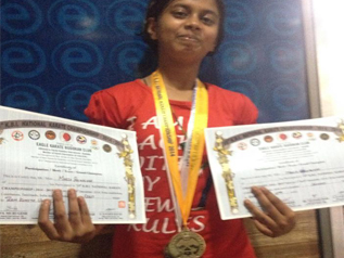 Student proudly displaying certificates and a medal
