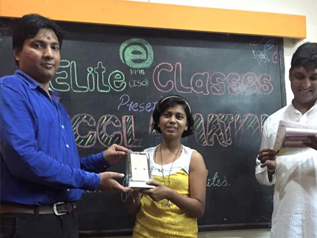 Student receiving recognition from an Elite Classes teacher